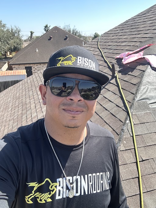 A Bison Roofing expert conducting a professional roof inspection on a residential home in Harlingen, Texas.
